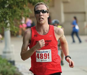 Jared Reynolds, a third-year student at IIT Chicago-Kent College of Law, charges to the finish line with a time of 16 minutes, 15 seconds at the 20th annual Race Judicata in Grant Park. 