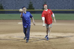 DuPage County Bar President Ted Donner and Kane County Bar President Larry Lobb throw out the first pitch in a softball face-off on Sept. 21 at Benedictine University in Lisle. The matchup between the two bar associations raised more than $10,000 for legal assistance programs in the two counties. Kane County managed to pull ahead of DuPage in the sixth inning, going on to win the game 2-1. 