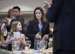 Shauna Prewitt of Skadden returns to her seat after getting a standing ovation from the crowd, including her daughter Isabella, after Prewitt received the Maurice Weigle Exceptional Young Lawyer Award.