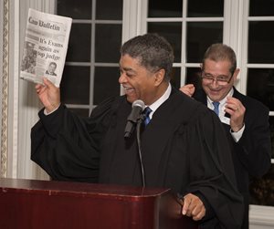 Chief Justice Timothy C. Evans shows off a Chicago Daily Law Bulletin announcing his re-election at the North Suburban Bar Association Installation Dinner on Sept. 20. David P. Pasulka of Pasulka & Associates, P.C., in the background, presented Evans the newspaper.